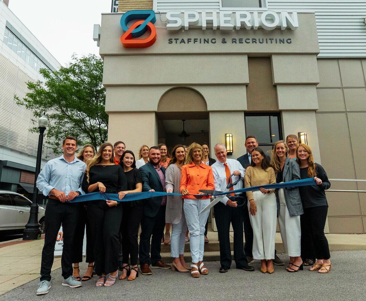 A group of professionals in front of a Spherion office
