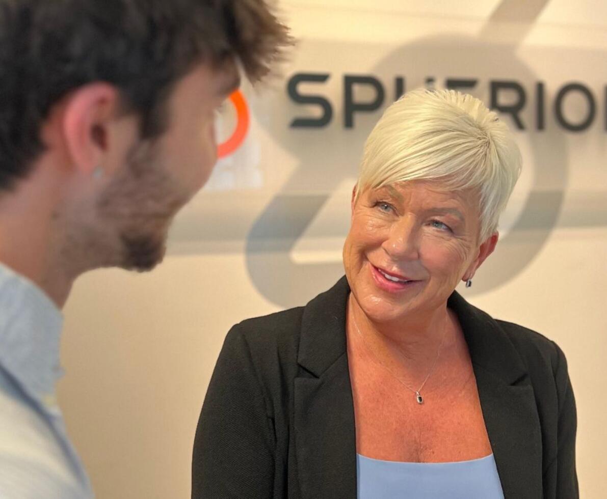 A professional woman talking with a colleague