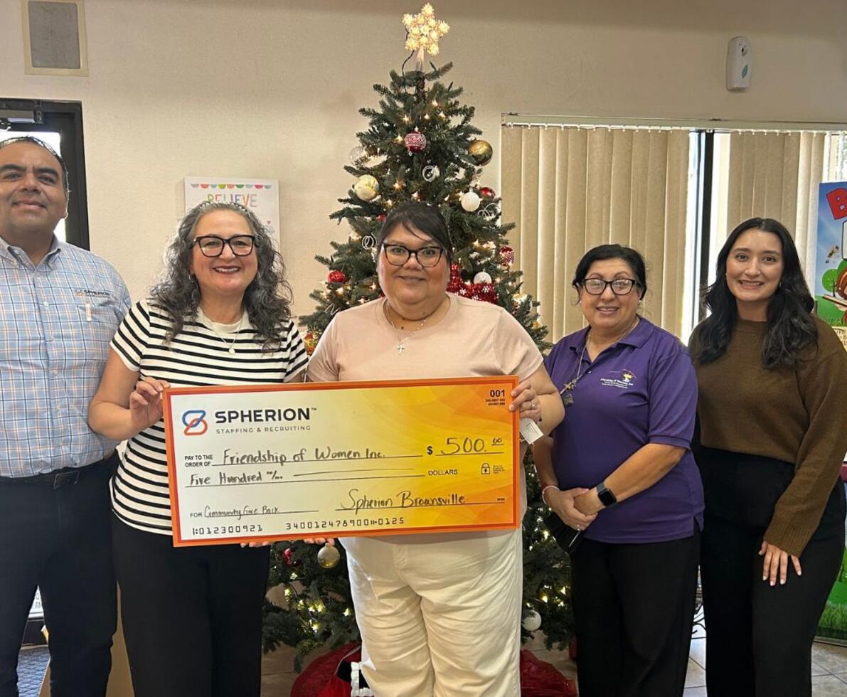A group of Spherion professionals holding a giant check