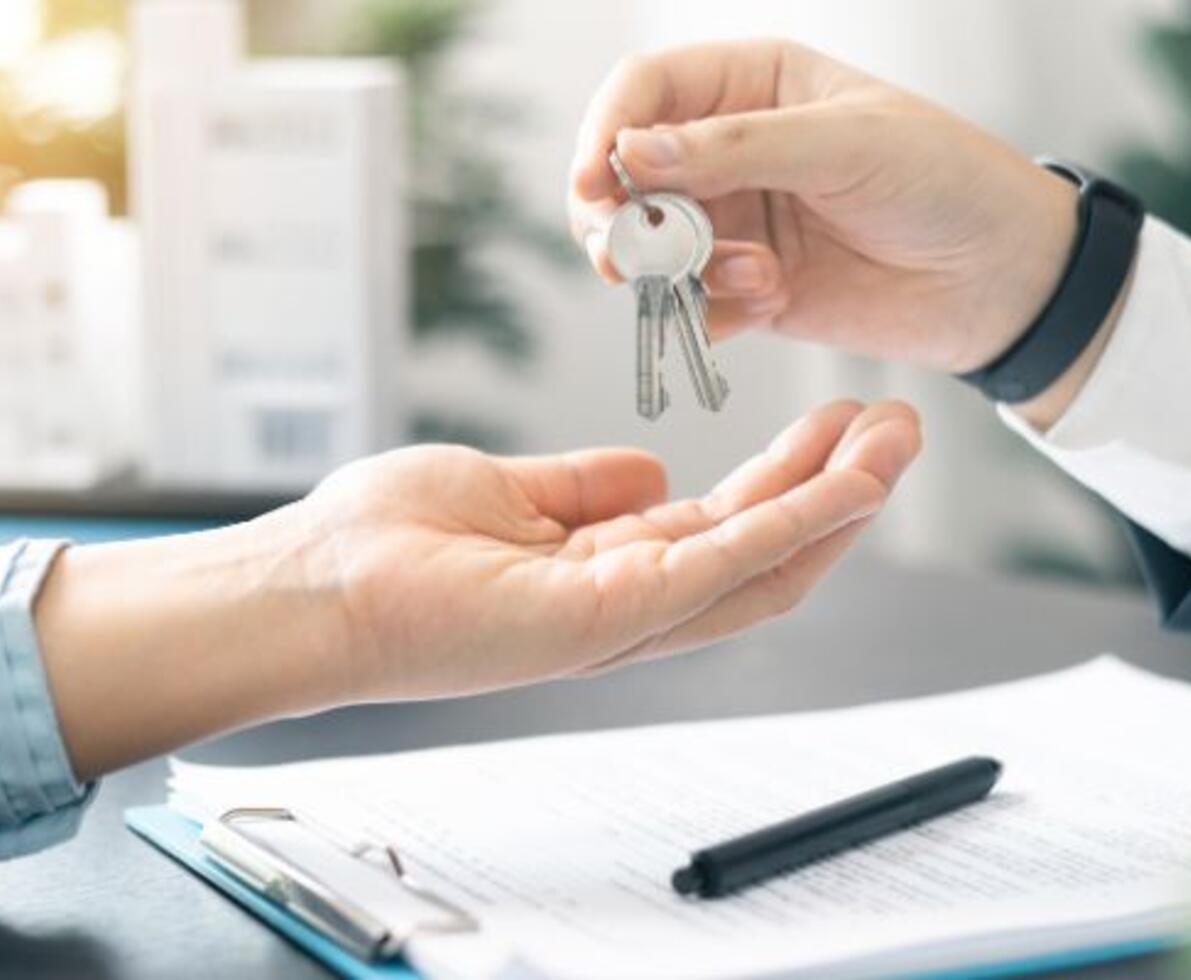 Close-up of handing over the keys to a new business owner