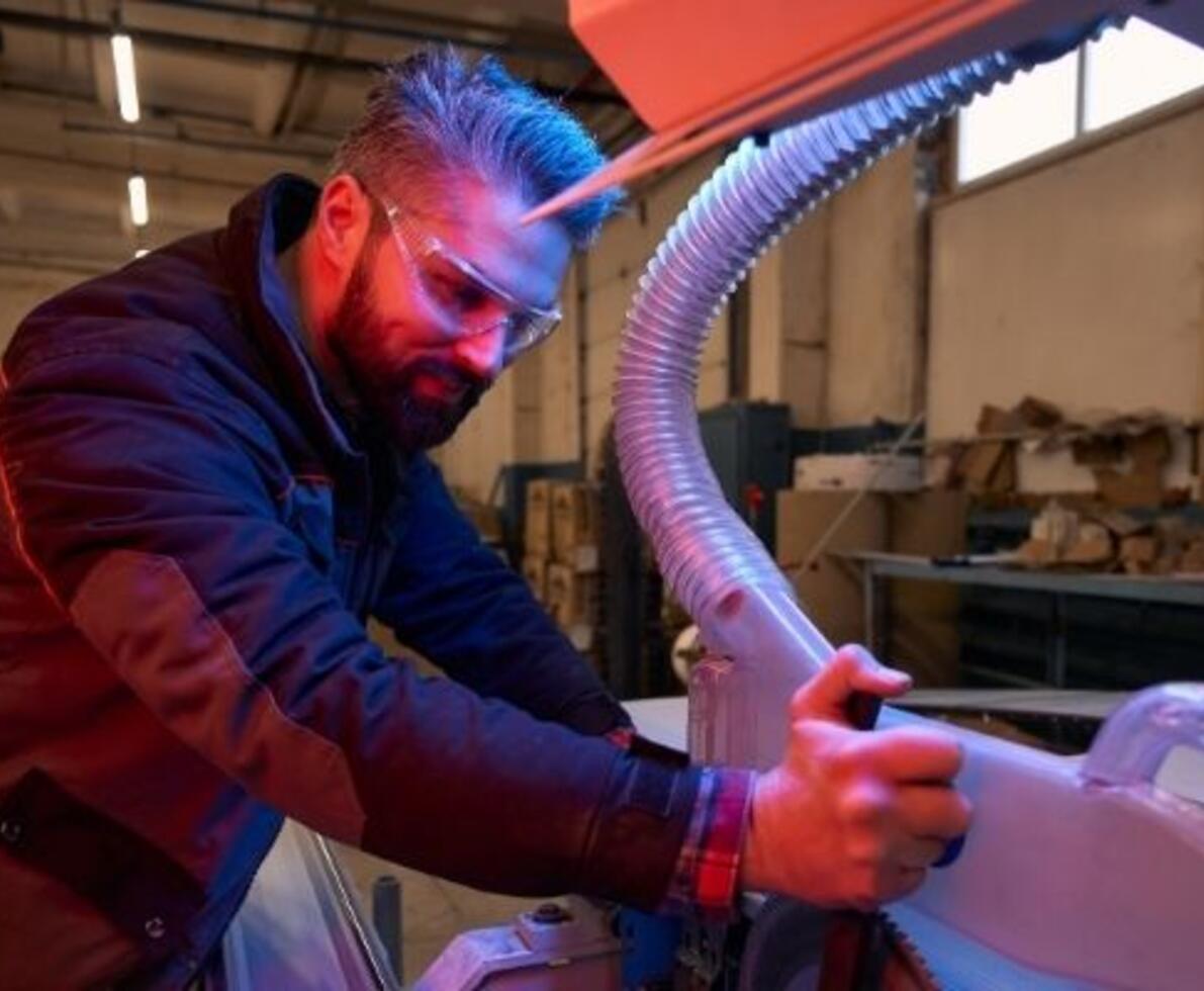 Portrait of a worker fixing a machine in a workshop