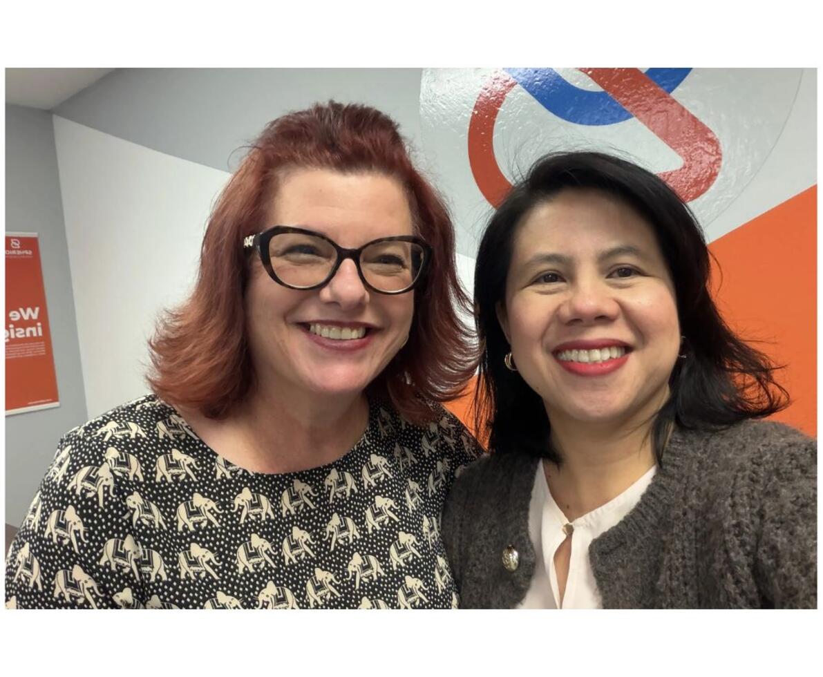 Two smiling women in a Spherion office