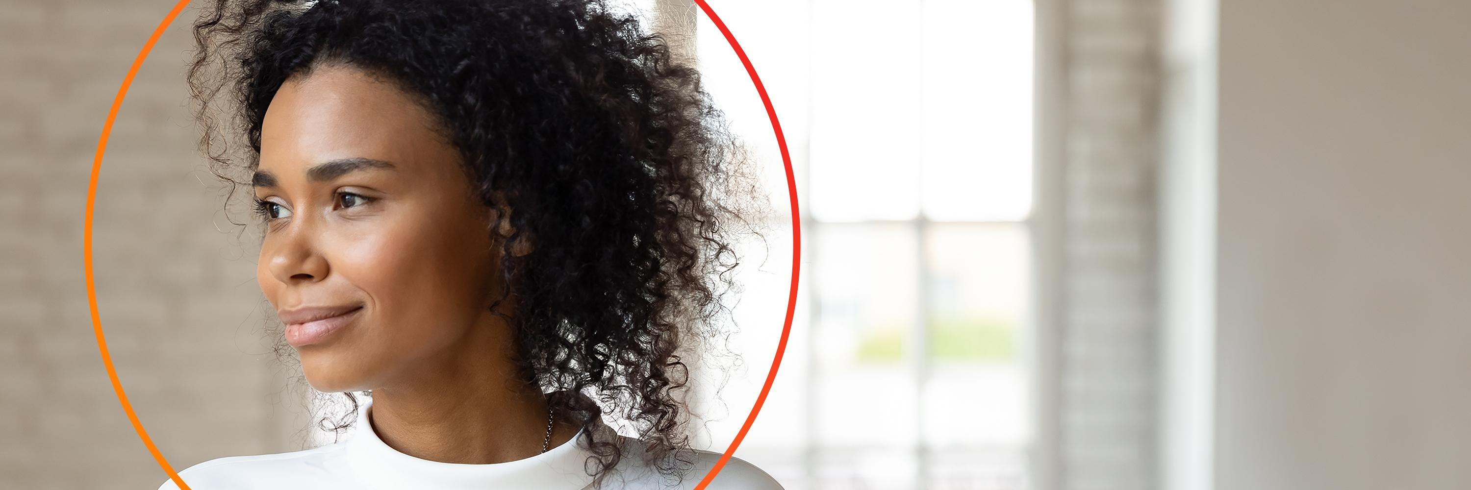 Aftican-American woman smiling looking left with orance circle around head