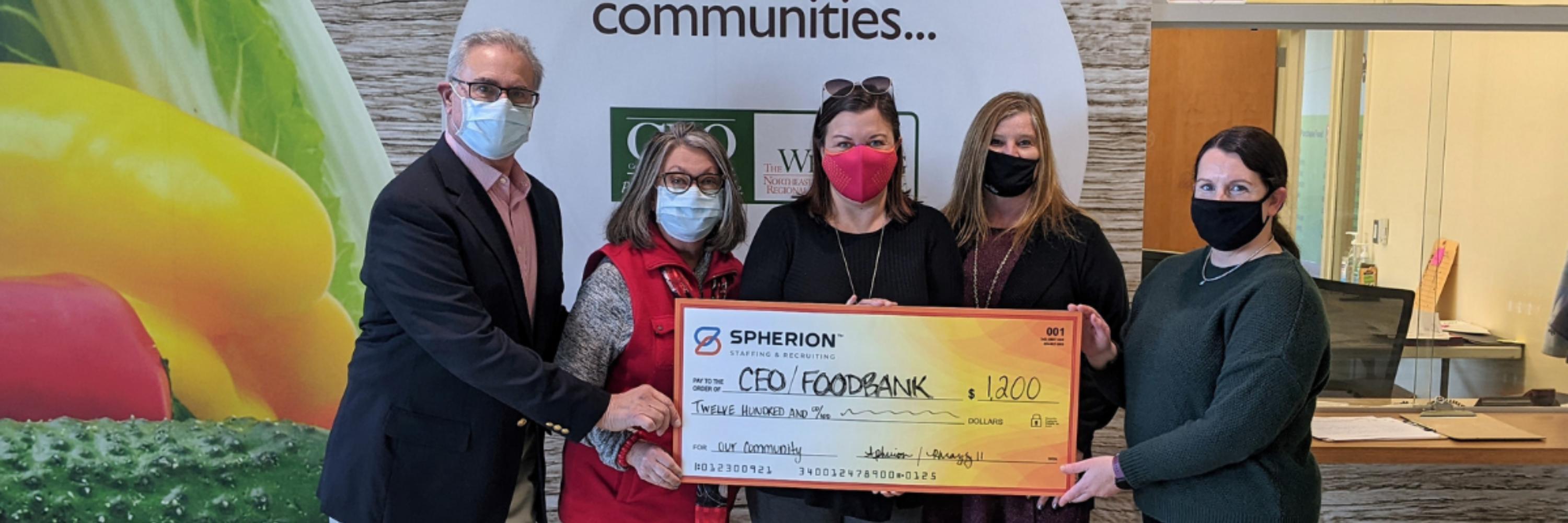 The Spherion Pennsylvania team presenting a giant check to a community food bank