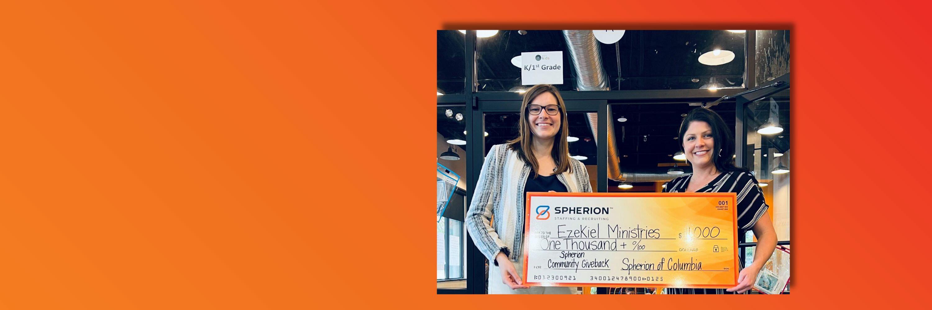 Orange background with a photo of two women smiling and holding a giant check