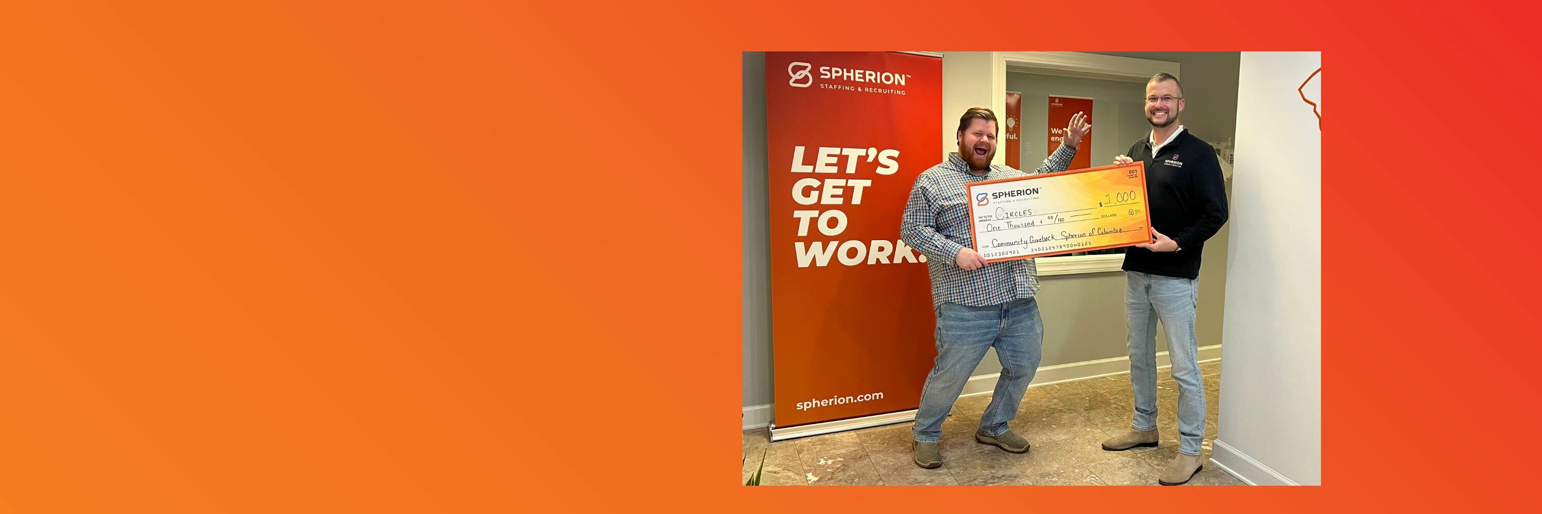 Orange banner with a photo of two men holding a giant check on the right side