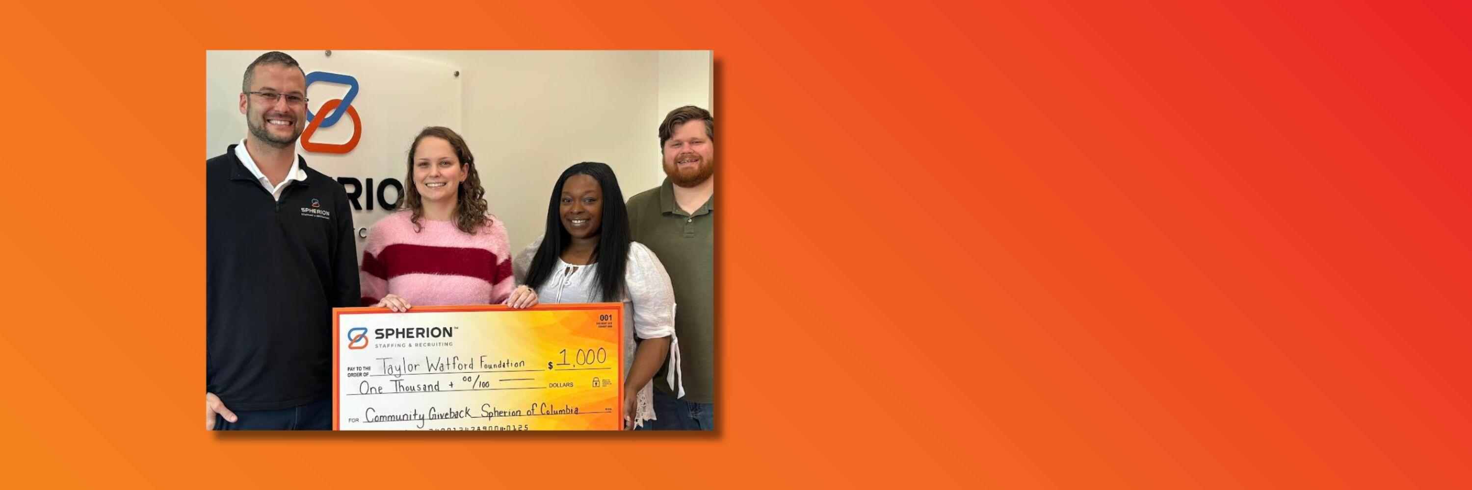 Orange background with a photo of four people holding a giant orange and yellow check for $1,000