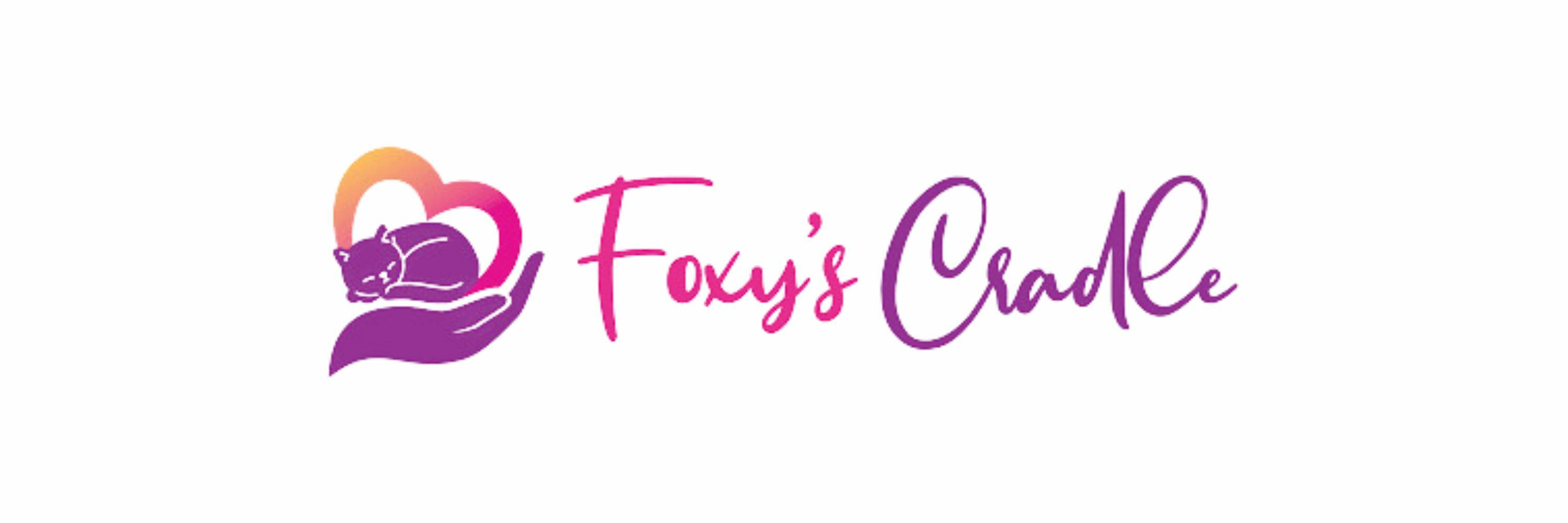 A purple and orange logo of a heart and kitten with the words, Foxy's Cradle