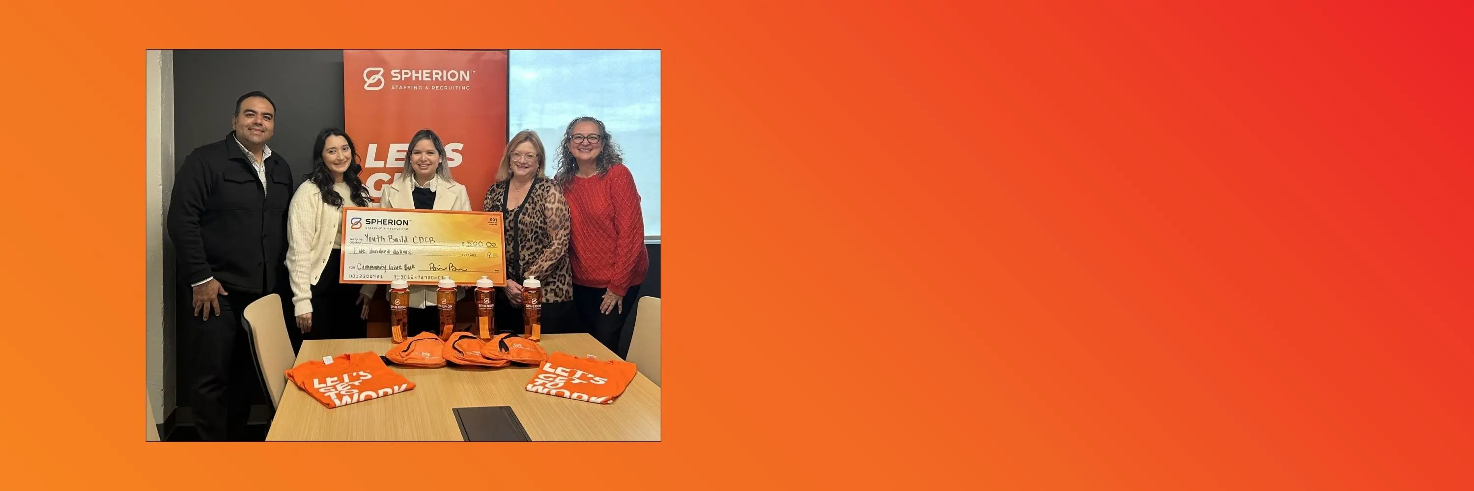 Orange background with a photo of a group of people presenting a check