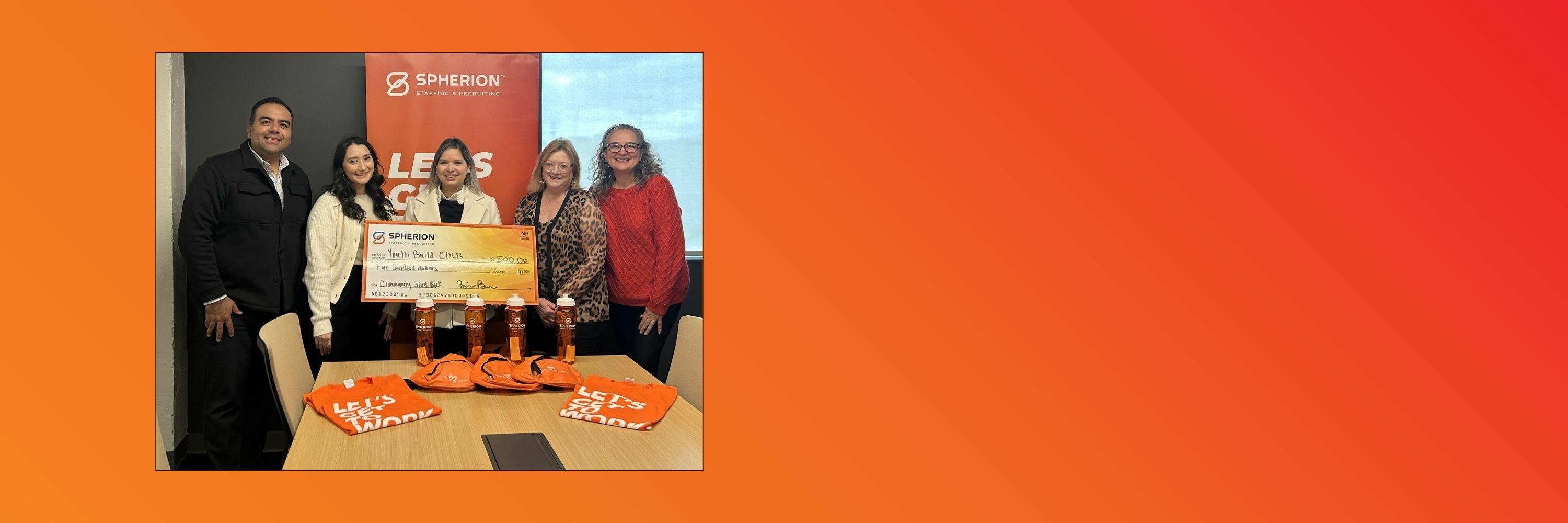 Orange background with a photo of a group of people presenting a check