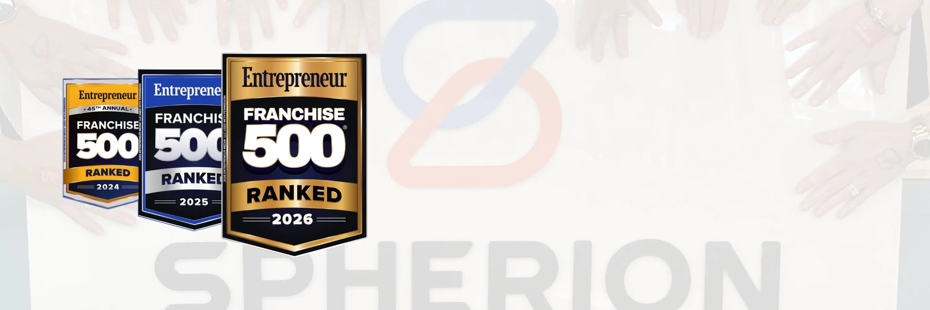 A faded photo of hands touching a Spherion banner with 3 Entrepreneur award badges on the left side