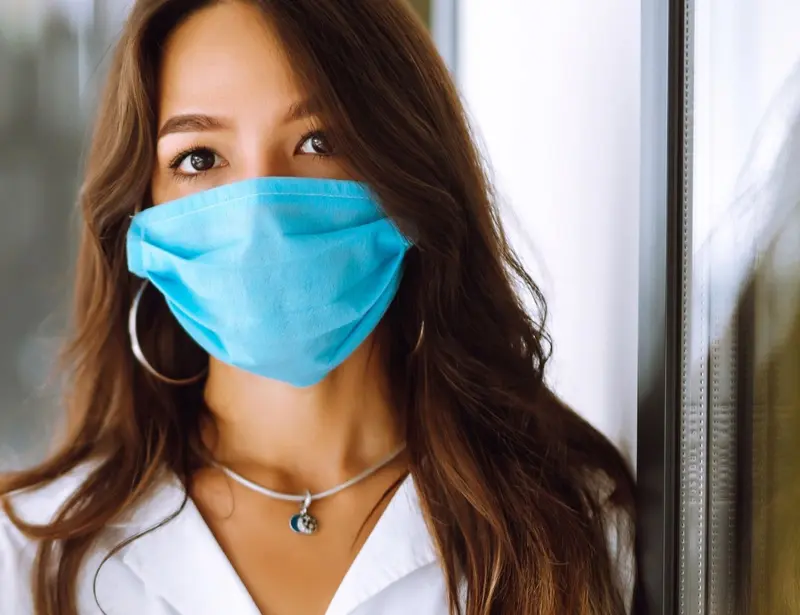 A healthcare worker in a blue face mask