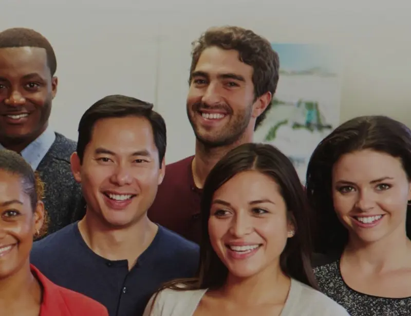 Group of diverse adults smiling at the camera