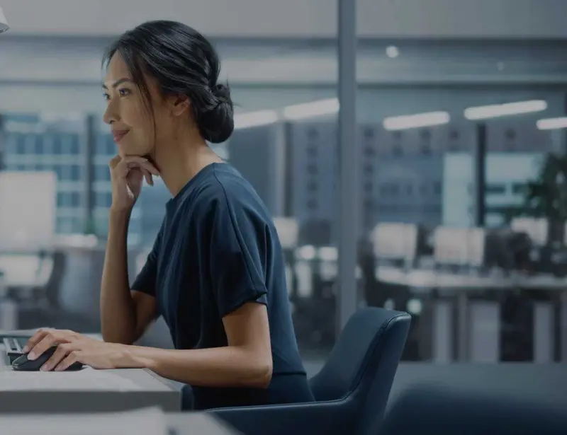 IT professional smiling while working at a computer