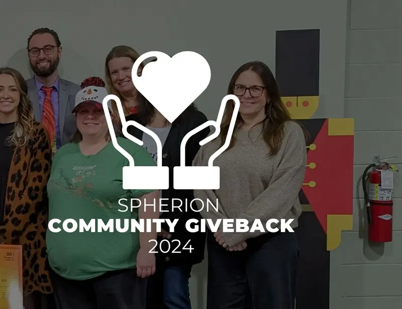 A group of professionals presenting a check to a nonprofit organization