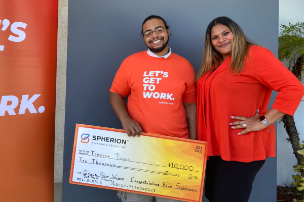 Treyvon Towns poses with his grand prize $10,000 check and Deborah Figueroa, client services specialist at Spherion's Port Saint Lucie, Florida office