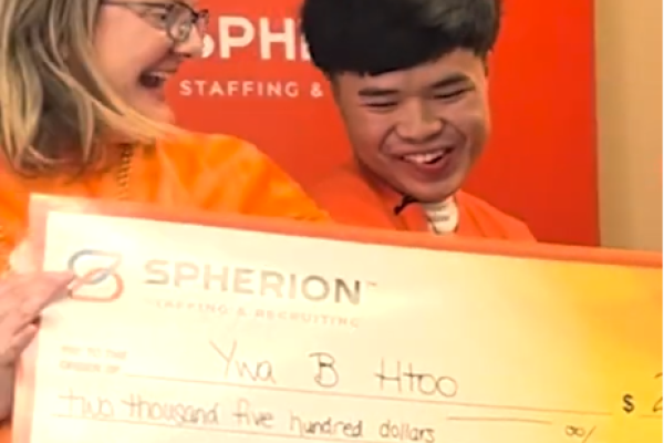 National Staffing Employee Week winner Ywa Htoo presented with a giant Spherion check