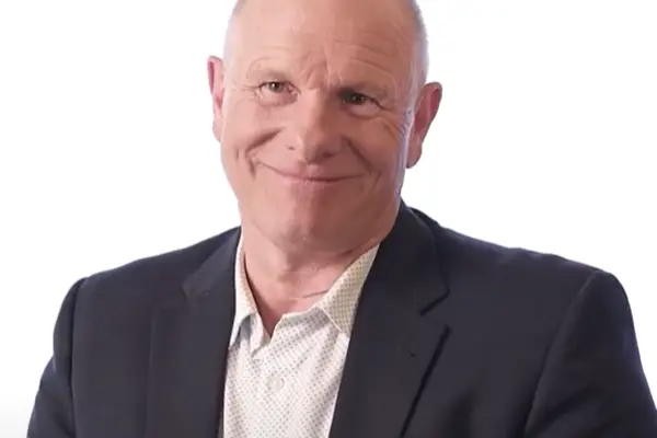 Ron Zarbock smiling at camera with Spherion logo in the upper right corner