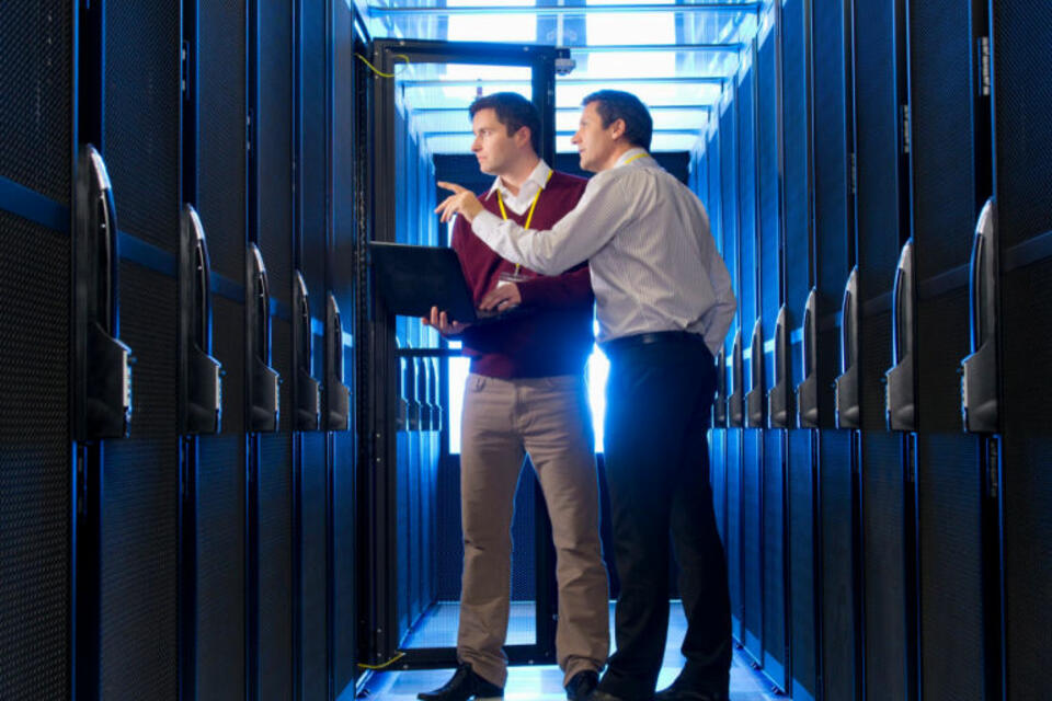 Two IT professionals in a server room
