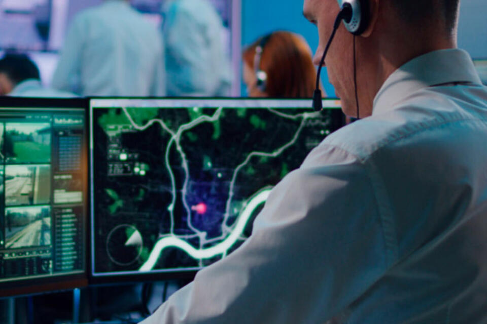 Man wearing a headset at a technology station