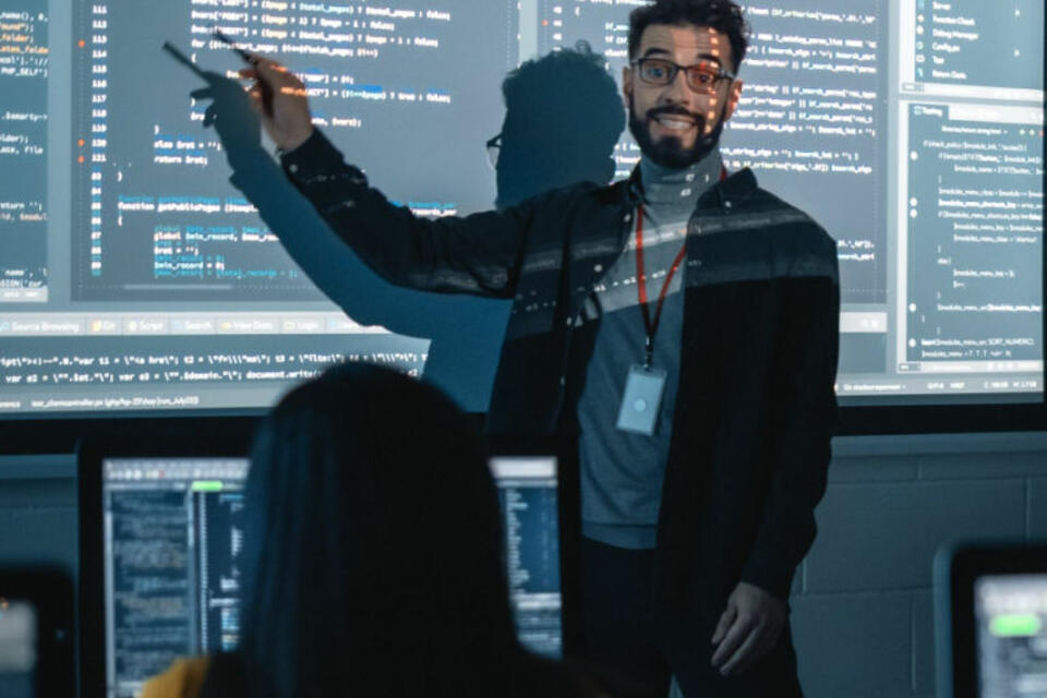 Hispanic man teaching a coding class