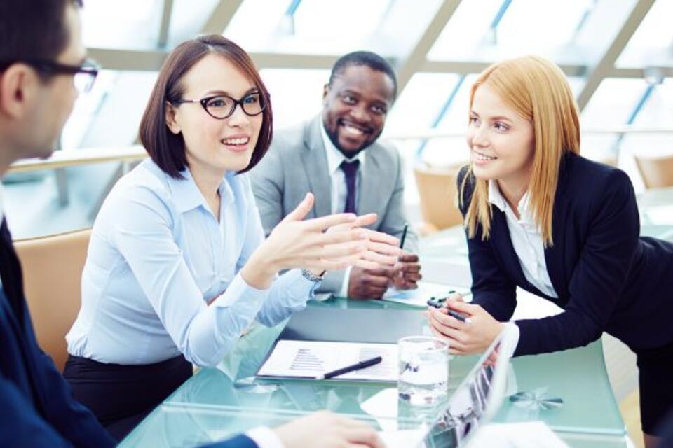 A group of professionals talking around a table
