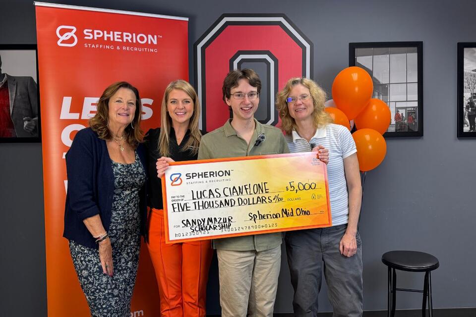 A group of people celebrating a scholarship check