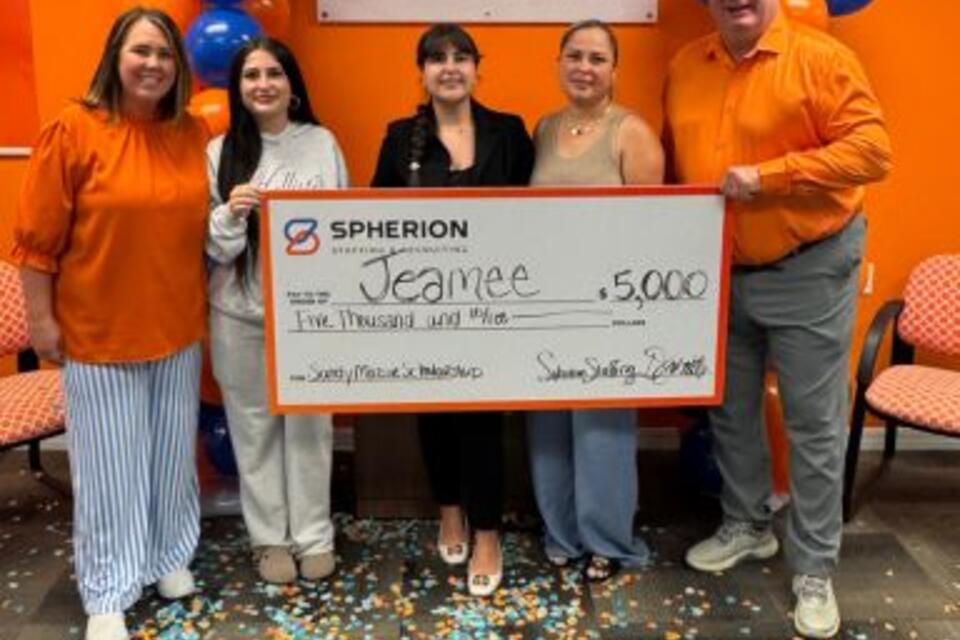 Jeamee Domingues-Montoya receives her Sandy Mazur Scholarship check