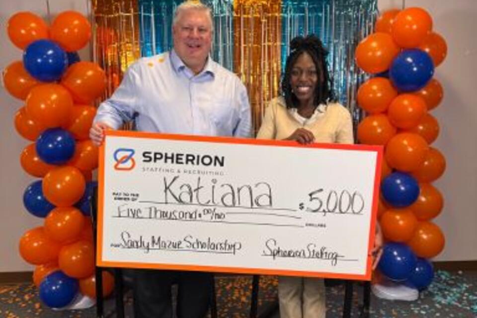 Katiana Delien receives her Sandy Mazur Scholarship check