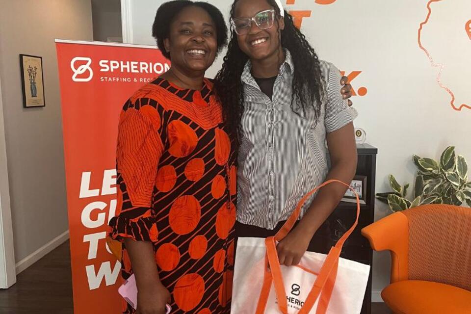 Two smiling women in an office setting