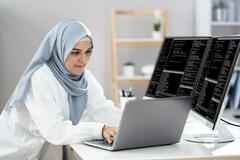 Woman_in_hijab_working_as_a_web_developer