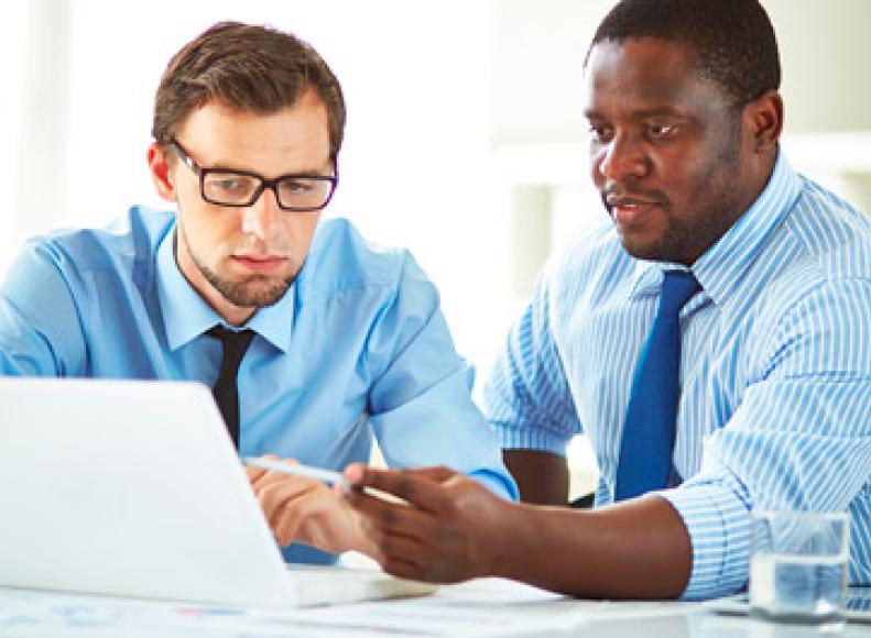 Two financial managers reviewing paperwork together
